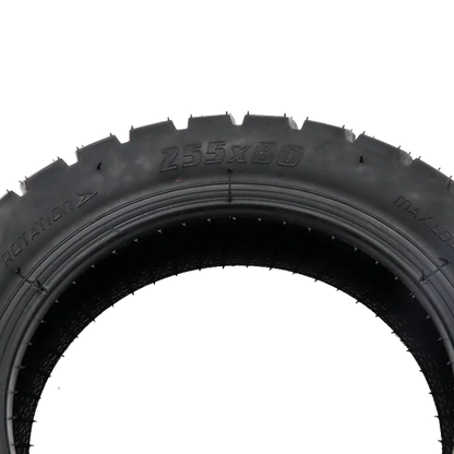 A close-up of a black rubber tire sidewall showing embossed text including 'Z55X80' and 'MAX LOAD', photographed against a plain white background.